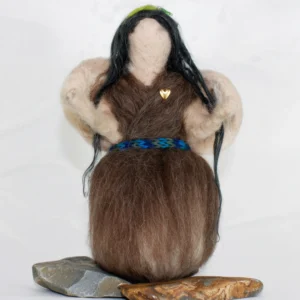 MariaElena | Handmade needle felted angel with flowing black hair, cream wings, earth-toned dress, turquoise belt, and green crown, sitting on natural stones – Guardian of Inner Garden memorial angel